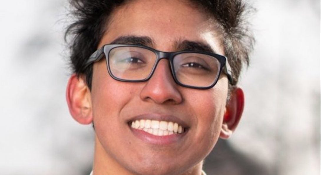 a boy in an untied red bowtie