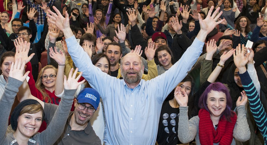 a group of people with their hands in the air